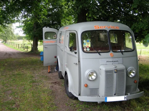 Der hellgraue Citroën-Transporter mit at-Aufschrift auf einem Feldweg