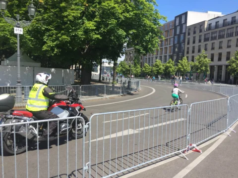 Ein Streckenposten in Warnweste an einer abgesperrten Straßenkurve
