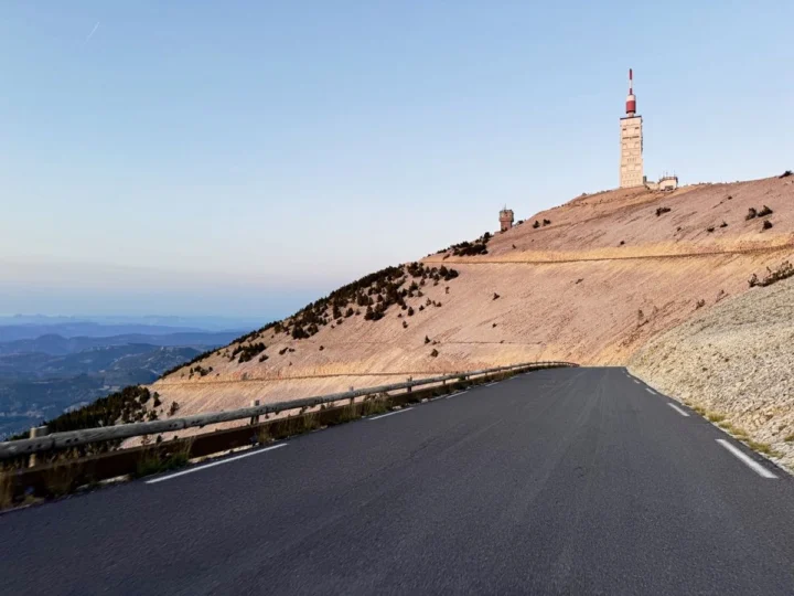 Die Straße knickt zum kahlen Gipfel des Mont Ventoux hinauf, oben der rot-weiße Wetterturm